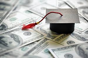 Graduate cap sitting on cash