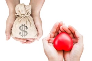 Hands Holding Money and Heart for people with group health insurance plan