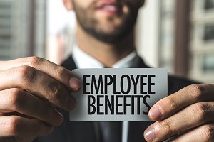 man holding employee benefits note