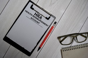 health reimbursement account write on a paperwork isolated on office desk