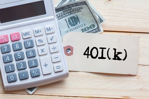 401k written on note with calculator and dollars