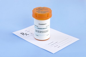 prescription bottle and script on blue background of  Insurance Premiums
