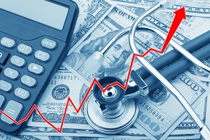 graph showing the high cost of health care with usd bank notes a stethoscope and calculator