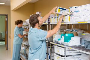 nurse staff restocking inventory shelves
